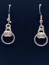 Seaxwolf handmade sterling silver four rings and small hoop earrings.